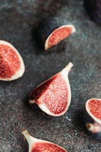 Macro photography of fresh ripe cutted figs on the textured background