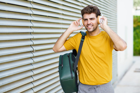 Young man with headphones in urban background