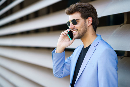 Man talking to his smartphone with a happy expression