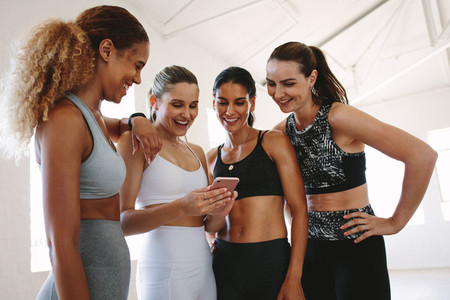 Gym women looking at mobile phone