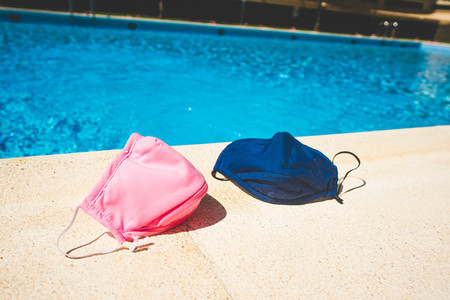 Protective mask near a swimming pool in summer