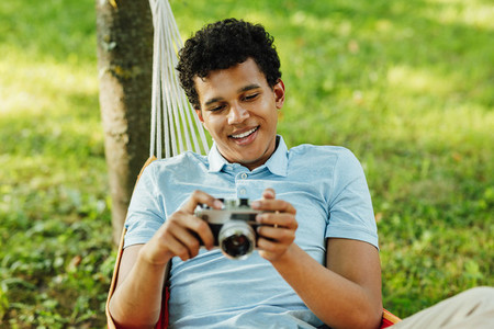 Young smiling man holding a film