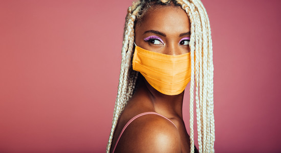 Woman with blonde box braids wearing face mask