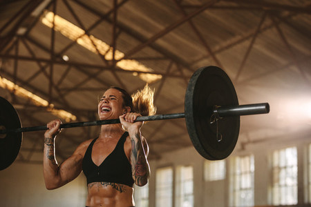 Bodybuilder woman doing weight lifting workout