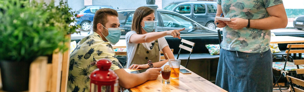 Couple with mask making food order to waiter