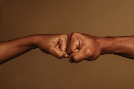 Close up of hands giving fist bump