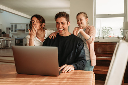 Family having video call on laptop
