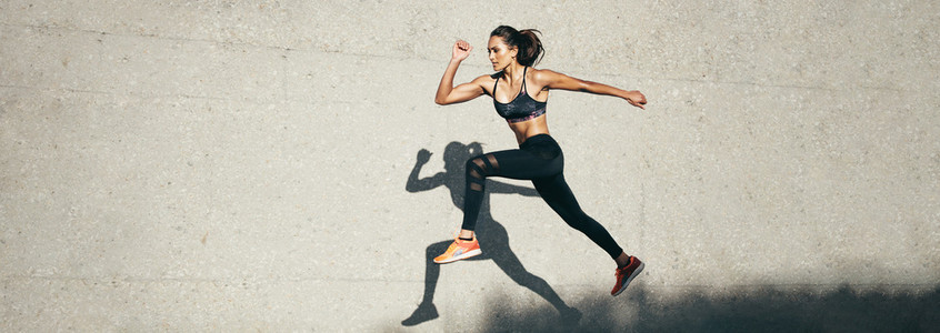 Fit woman jumping and running