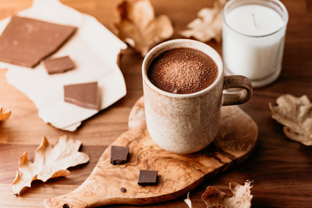 Close up of hot chocolate in a ceramic mug on the table  Autumn or winter cozy still life