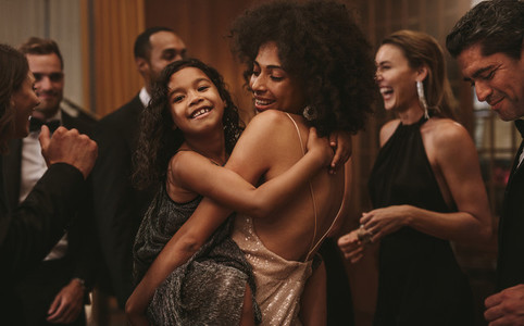 Girl dancing with her mother at a gala night event