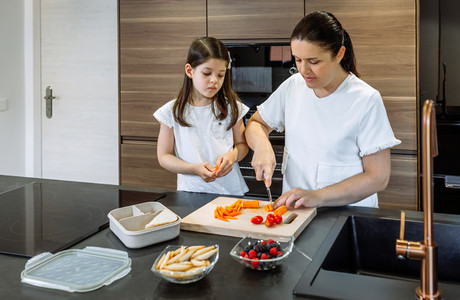 Mother preparing healthy snack for her daughter for school