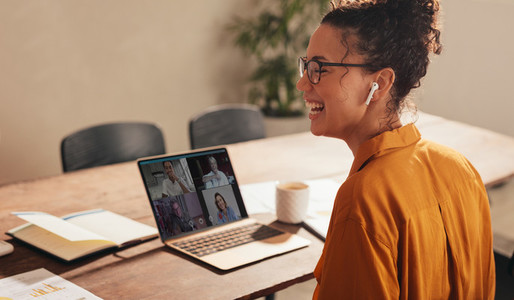Businesswoman laughing during a video call with team