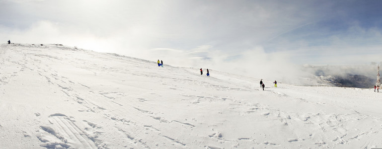 People having fun in snowed mountains in Sierra Nevada
