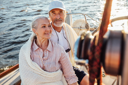 Mature couple sitting on yacht