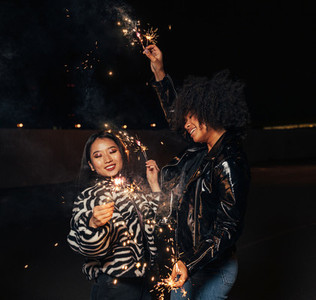 Two happy girls with sparklers