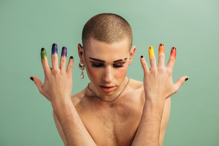 Gender fluid male with lgbt rainbow colored fingers