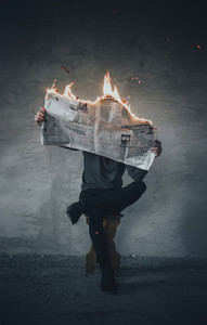 Man with burning newspaper