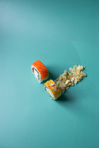 two sushi on light cyan background
