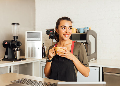 Smiling female barista looking