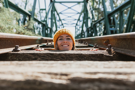Woman has fun exploring an old  abandoned iron railroad bridge