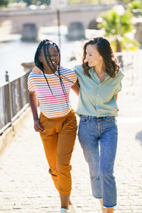 Two Multiethnic women walking together on the street