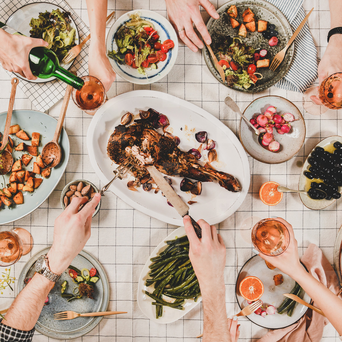 Flat lay of people eating and drinking rose wine square crop