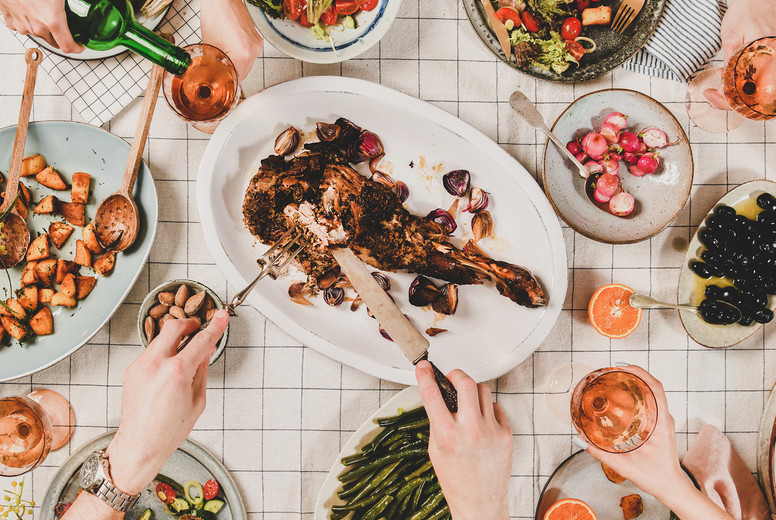 Flat-lay of people eating and drinking rose wine, square crop
