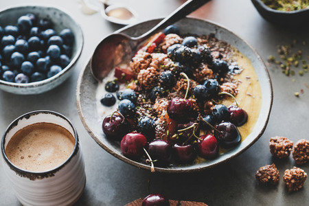 Healthy breakfast with quinoa granola coconut bowl and coffee