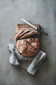 Freshly baked sourdough bread on wooden board  vertical composition