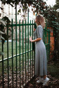 Girl leaning on fence on rural property