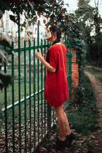 Girl leaning on fence on rural property