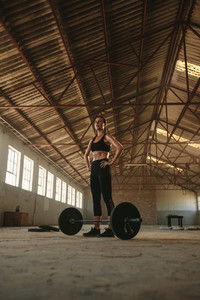 Woman taking break from weight lifting workout