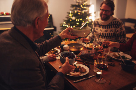 Family celebrating Christmas eve with delicious food
