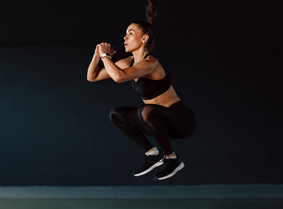 Sports woman jumping in gym