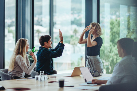 Business people celebrating success in conference room