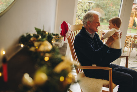 Elderly man with his grandson on a christmas eve