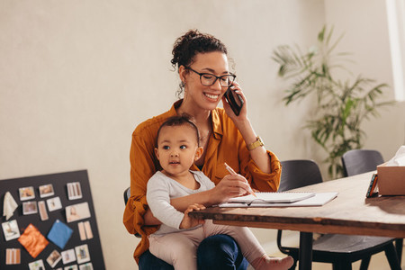 Working mom with child talking on phone