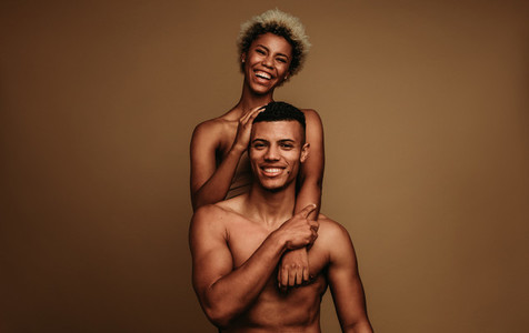 Happy african american couple together on brown background