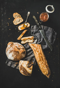 Flat lay of baguette  bread loaf and apricot jam