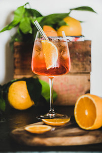 Aperol Spritz cocktail in glass with eco friendly straw close up