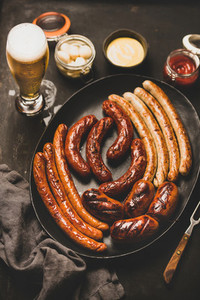 Flat lay of bavarian dinner with beer  sausages  sauce in jar