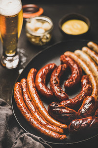 Bavarian dinner with beer  sausages  sauce in jar  selective focus