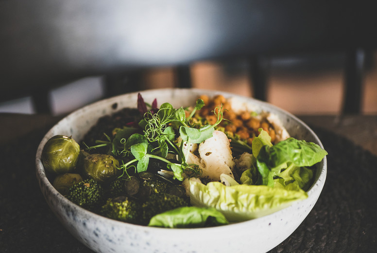 Healthy dinner with Buddha bowl with hummus, vegetables and beans