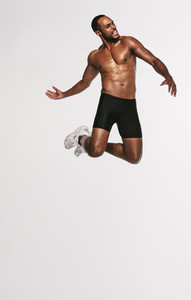 Fit man jumping in air during workout