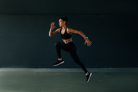 Sportswoman jumping in gym