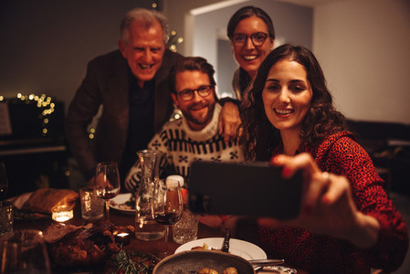 Family taking selfie during Christmas dinner