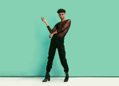 Gender fluid man with womens clothing posing at studio