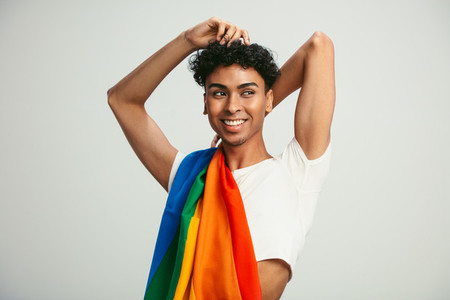 Man with a gay flag on his shoulder