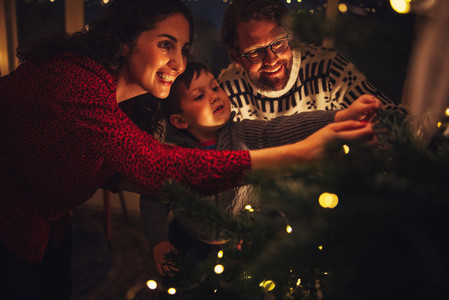 Small family decorating Christmas tree