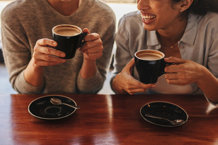 Two friends having coffee together